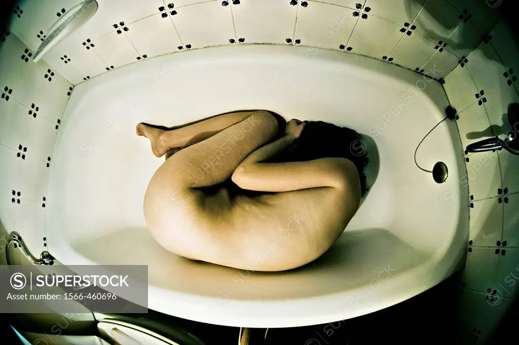 fetal position in a bathtub