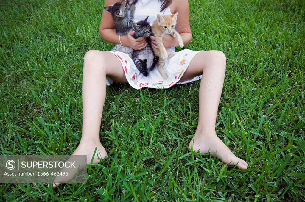 Little girl with kittens