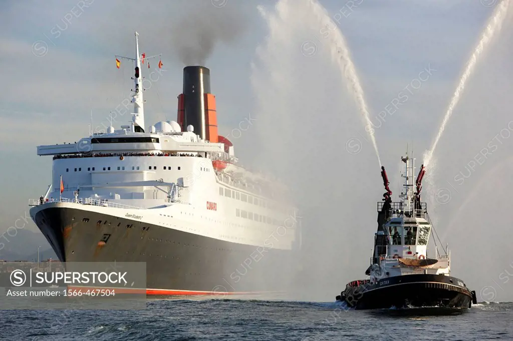 Tugboat and cruise liner Queen Elizabeth 2. Port of Bilbao, Biscay, Basque Country, Spain