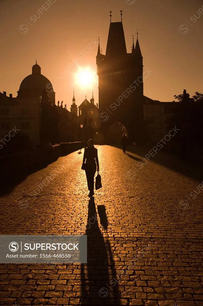 Silhouette Of Woman Walking Across King Charles Iv Bridge. Prague. Czech Republic.