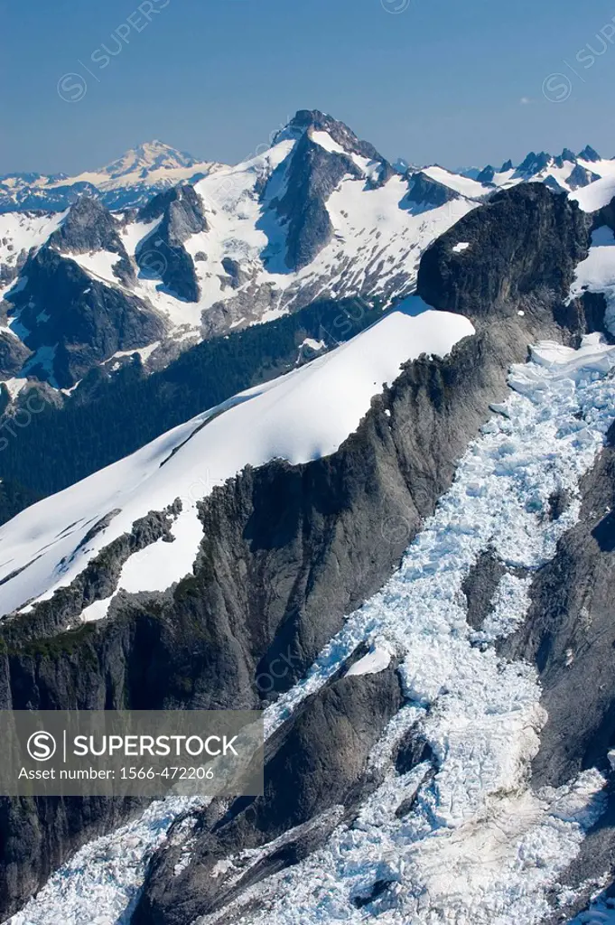 Icy Peak 7073 feet, 2156 meters displaying the Spillway Glacier, seen from the summit of Ruth Mountain Mount Blum is in the distance, North Cascades W...