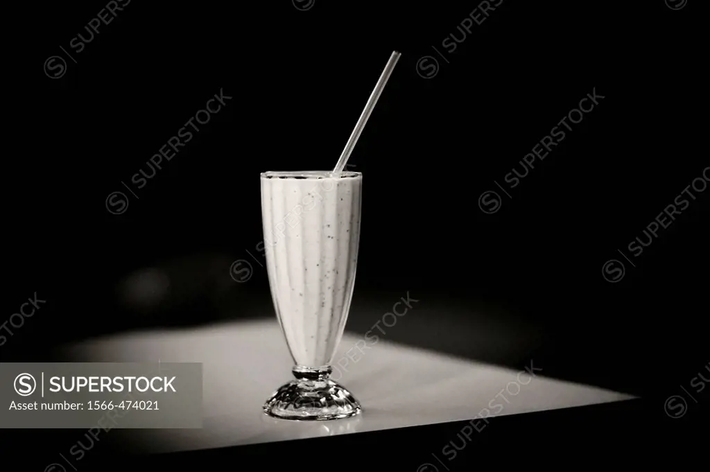 Strawberry milkshake on table, black and white still life