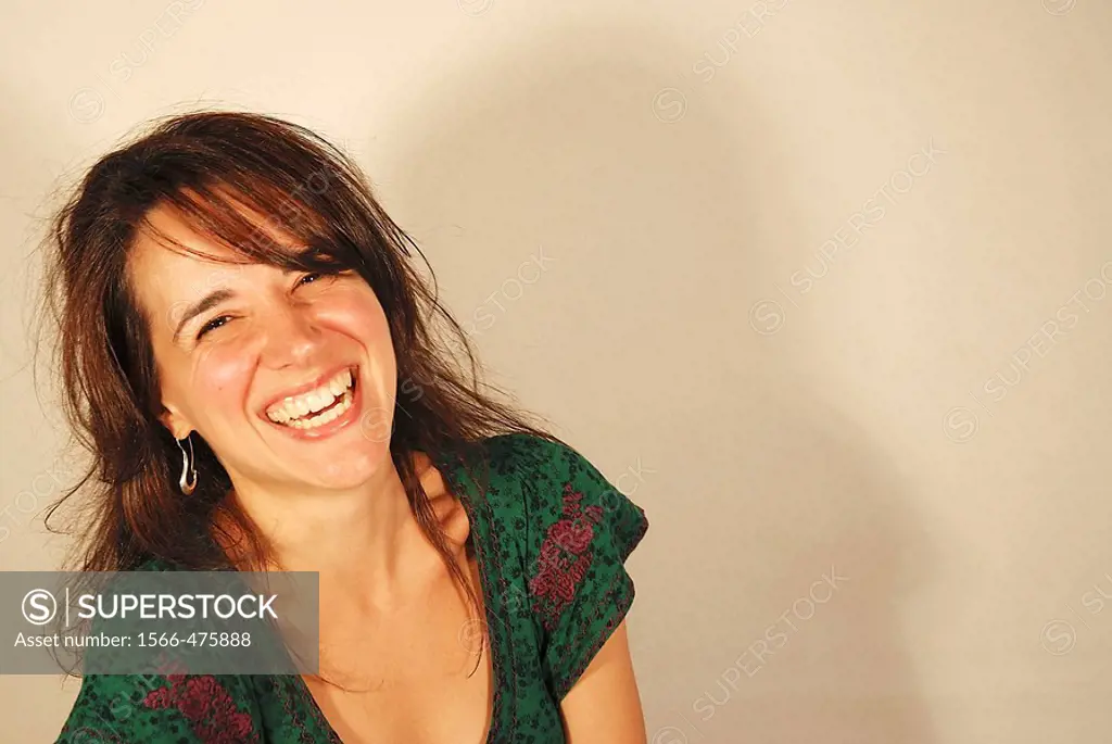 Portrait of young woman laughing and looking at the camera