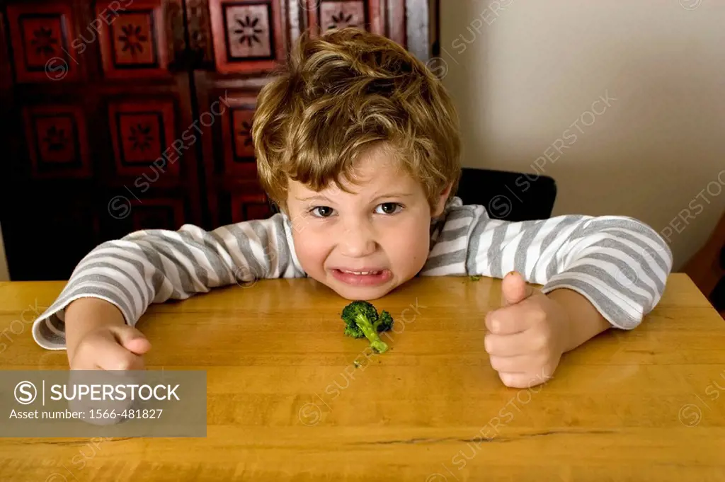 Five year old boy who doesn´t want to eat broccoli.