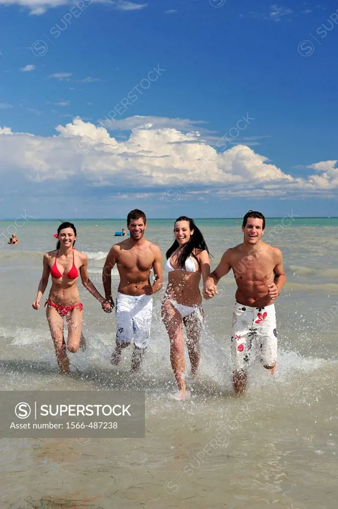 Boyss running on the beach.