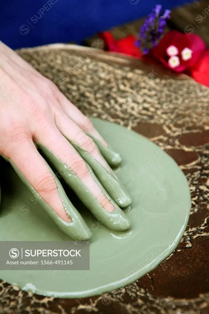 Hands and green clay preparing health theraphy