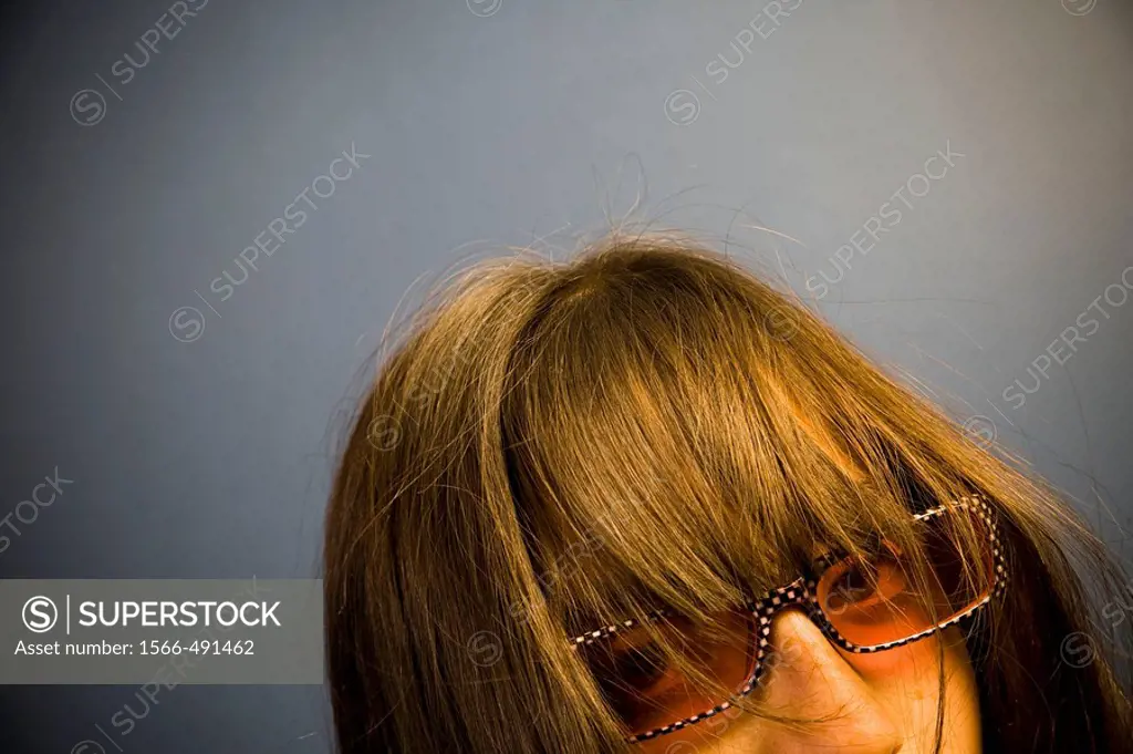 Preteen girl, wearing sunglasses, posing.