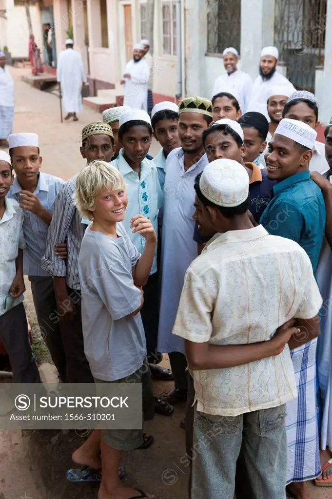 Muslim boys talk to a tourist in Galle Fort, Sri Lanka