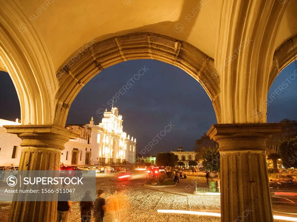 Arch with cathedral, seen through collonade off central square in Antigua, Sacatepequez, Guatemala