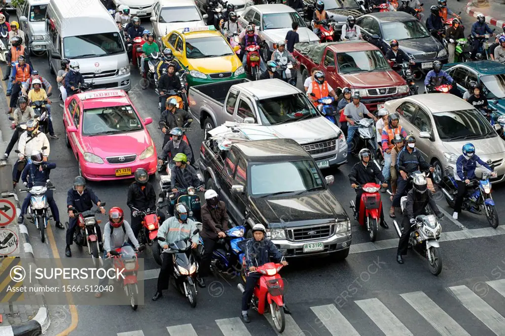 Traffic jam - cars and motorcycle waiting at a red light on Rhatjadamri Road in the centre of Bangkok, Thailand, Southeast Asia