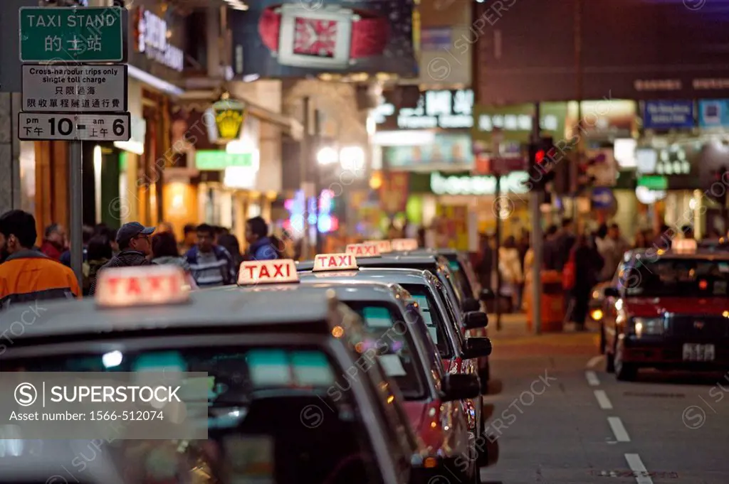 The typical red taxis queueing up idle at a taxi stand in Wanchai (Wan Chai) and waiting for customer, Hong Kong Island, Hong Kong, China, Southeast A...