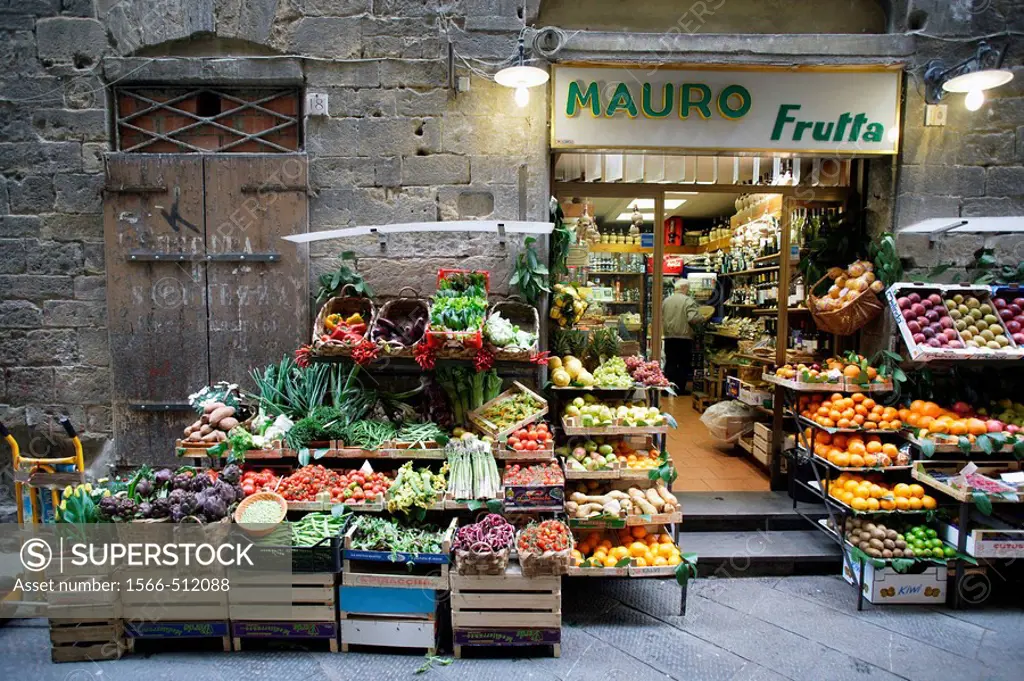 Traditional grocery store selling fruit and vegetable - and a pushcart besides - in a side street of the heart of Florence (Firenze), Tuscany, Italy, ...