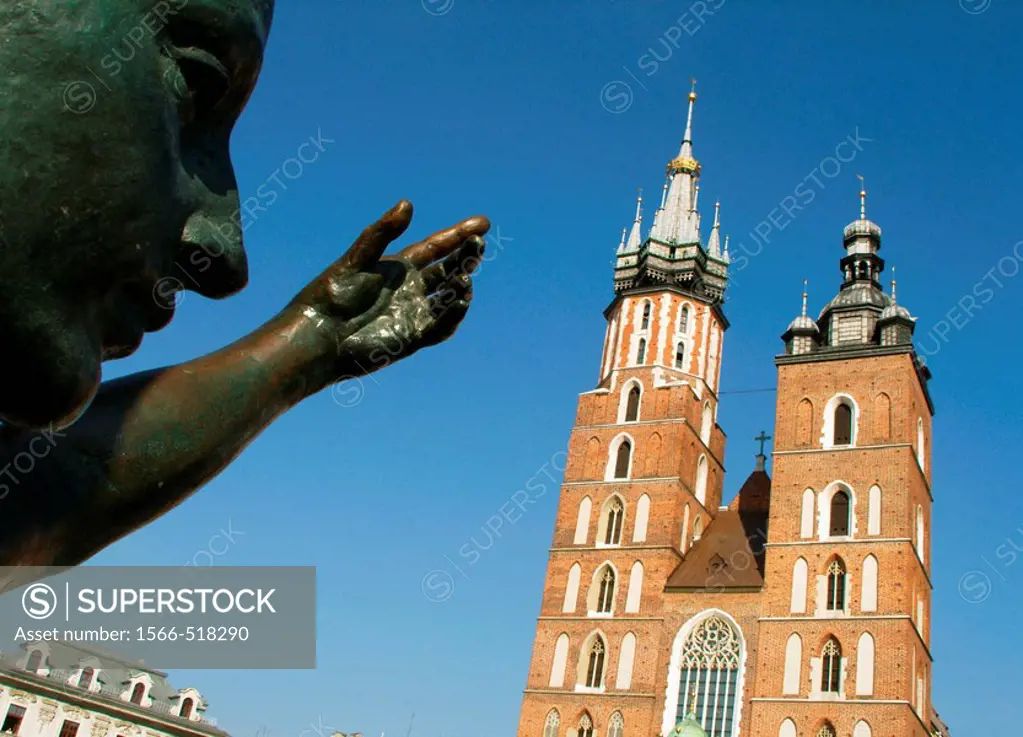 Poland, Krakow, Monument of great Polish poet Adam Mickiewicz, detail and St mary´s Basilica