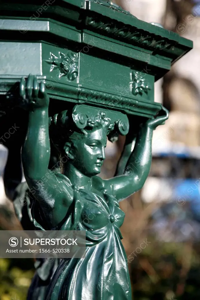 A closed up view of a figure on a drinking fountain in Montmartre, Paris. France