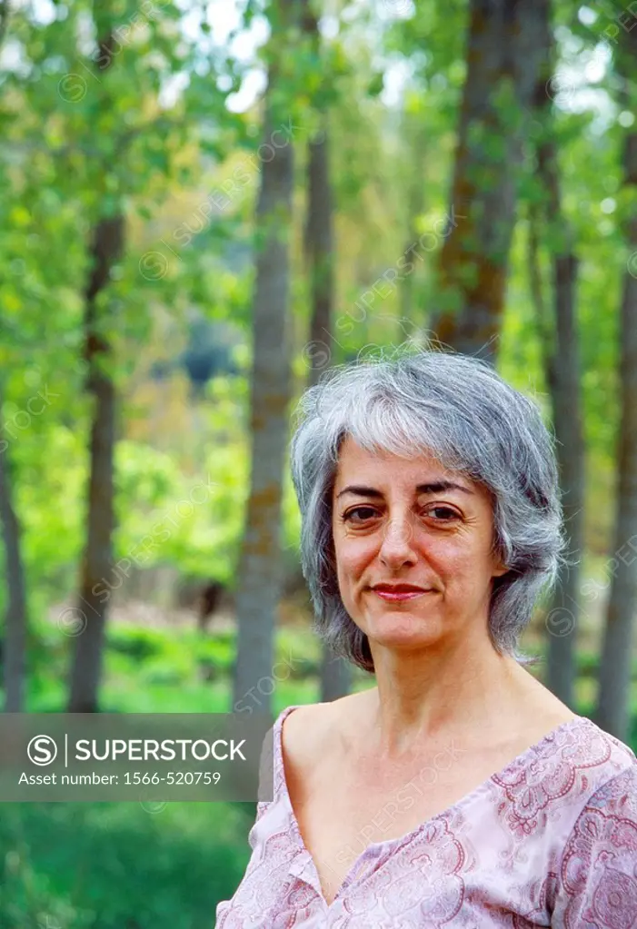 Portrait of mature woman in the woods