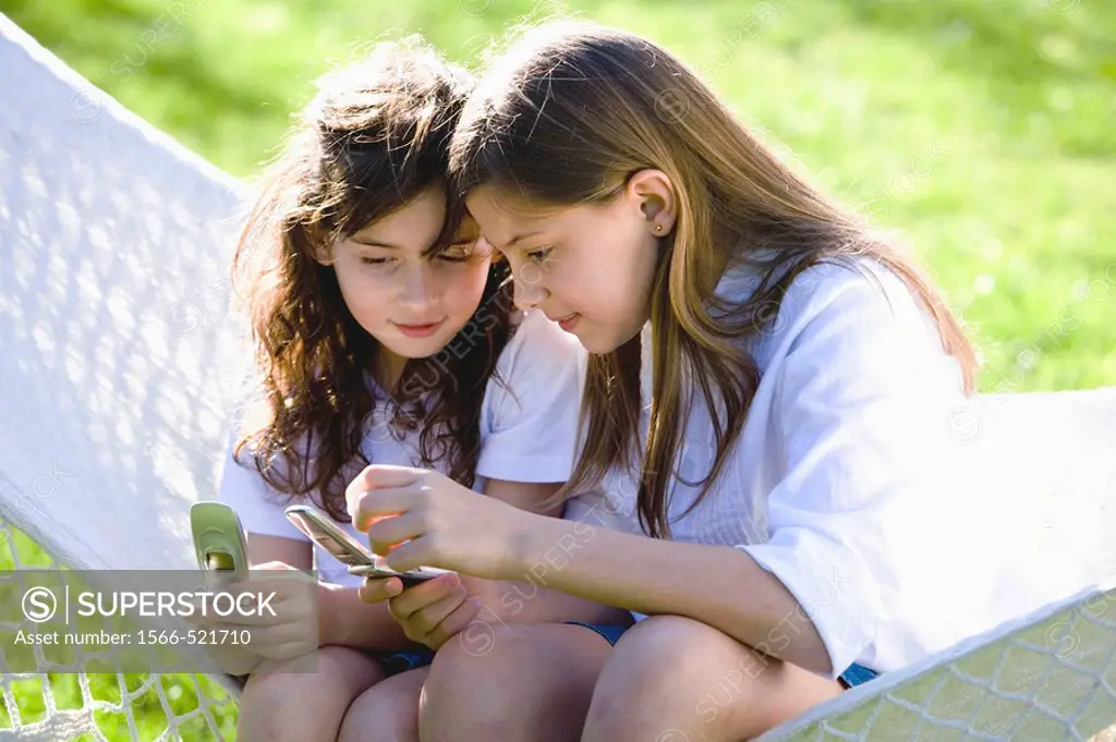 Two girls using their mobile phone