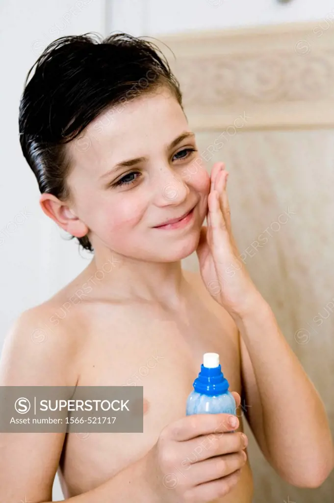 Boy applying perfume