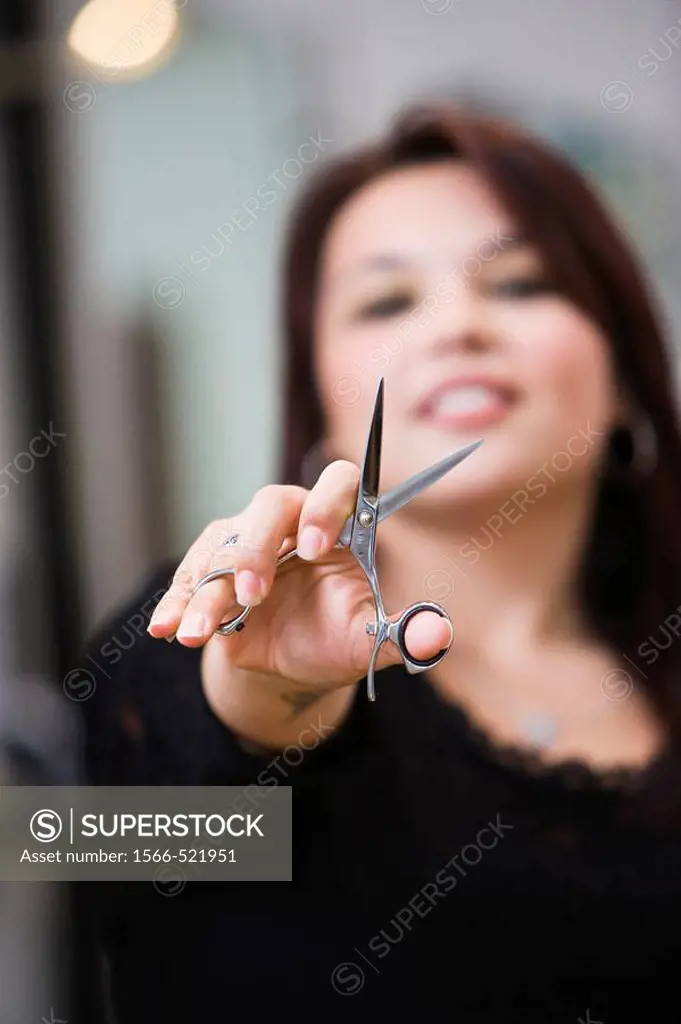 Hispanic hairdresser, holding scissors, smiling, portrait