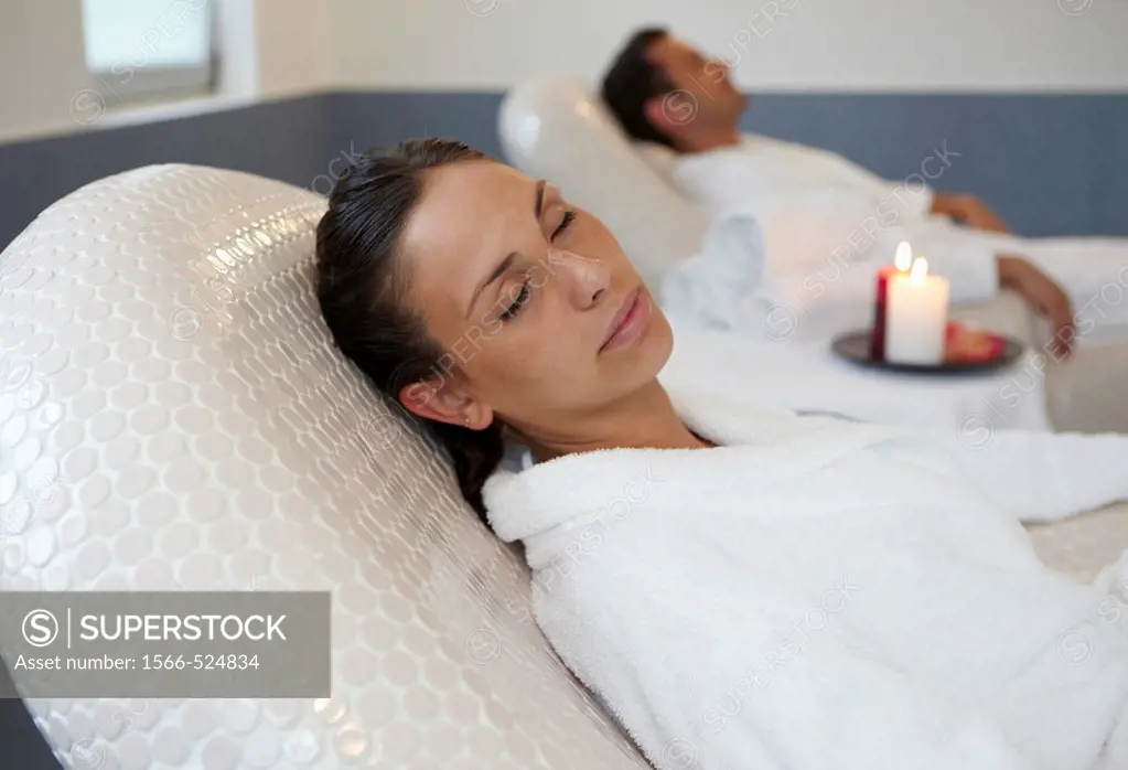 Woman relaxing on hot stone seat, Spa-relais
