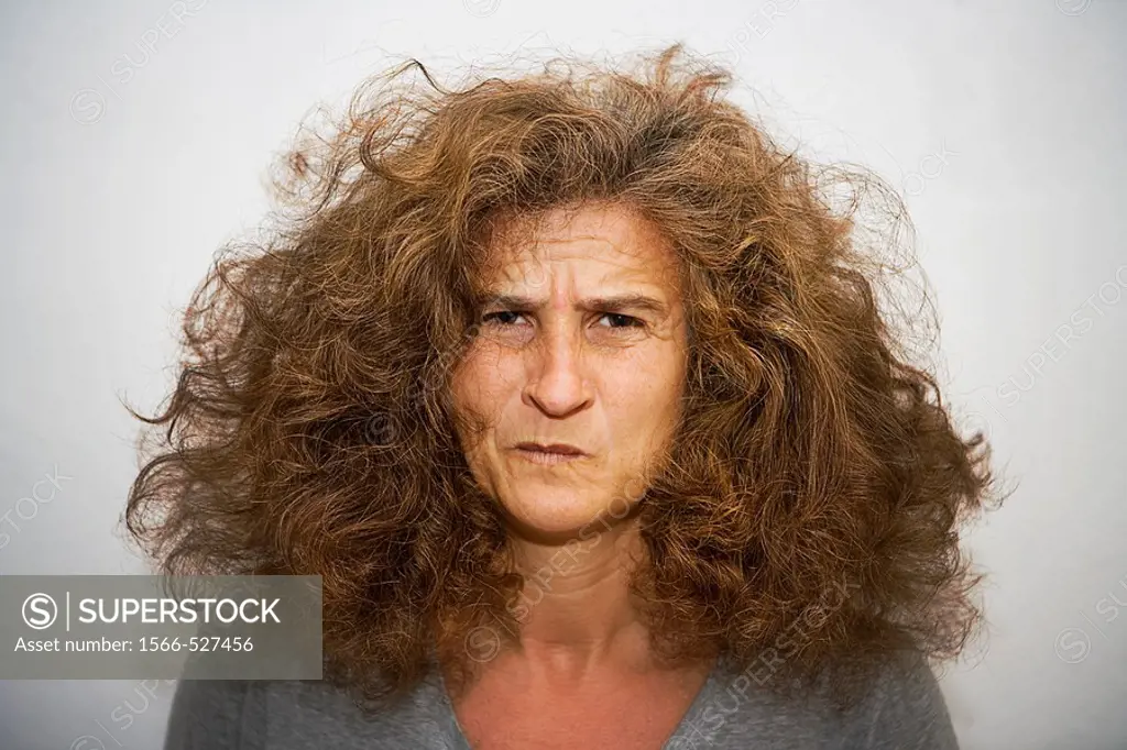 Disheveled woman with an expression of pain.