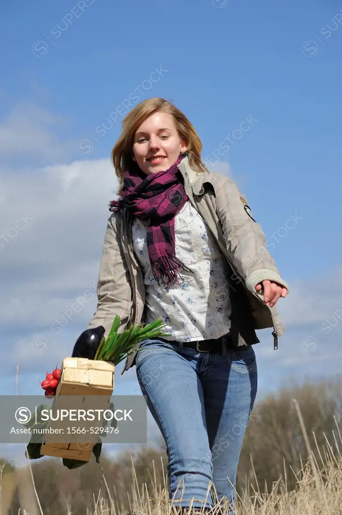 Young woman with vegetable basket