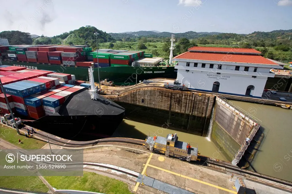 Mechanical mule or electric locomotive guiding container ship through Miraflores Locks, Panama Canal, Panama