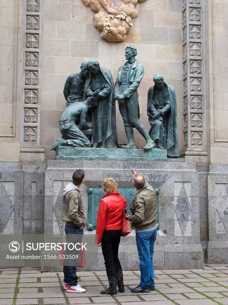 Tourists in the Gothic Quarter. Barcelona. Spain. This is the Monument to the Martyrs of 1809, at Garriga i Bachs Square in the Gothic Quarter (Barri ...