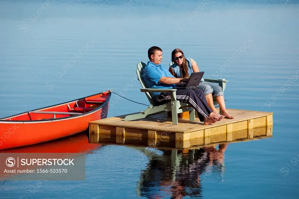 couple on dock with canoe