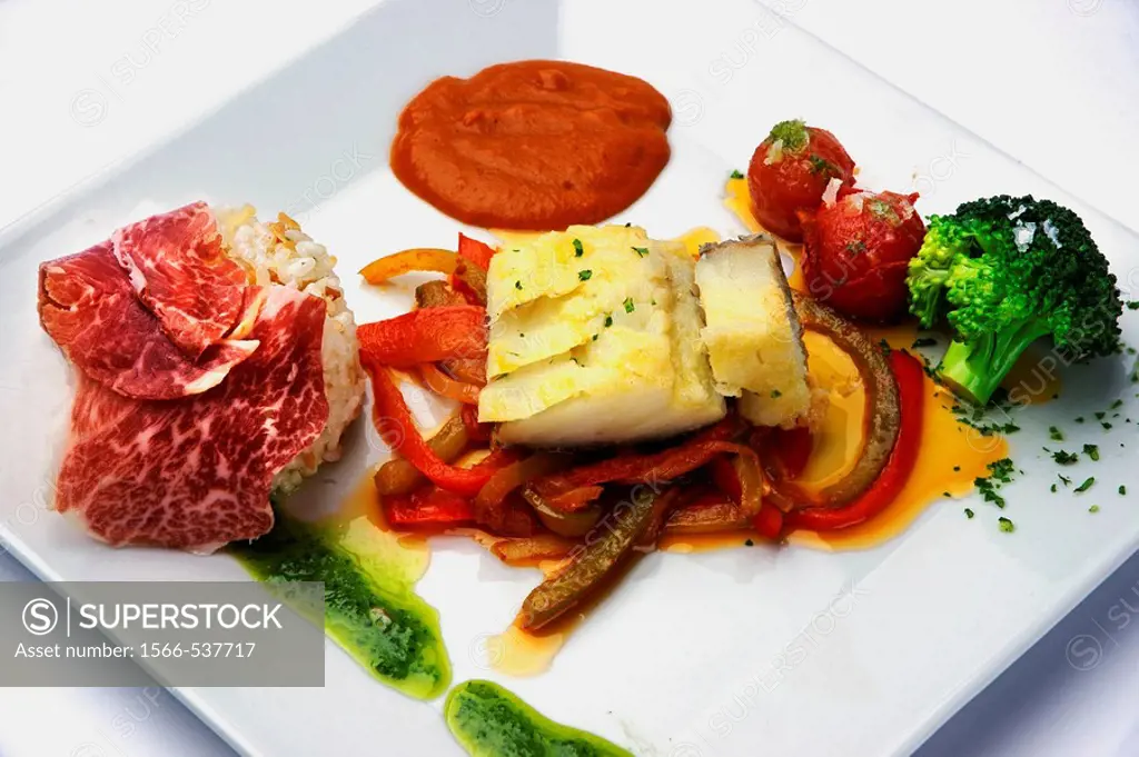 Cod fish with Iberian ham and red peppers salad at Barbacoa Andaluza restaurant, Mijas. Malaga province, Andalusia, Spain