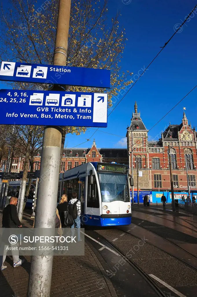 Tramway in front of the central train station built in the late 19th century, Amsterdam, The Netherlands