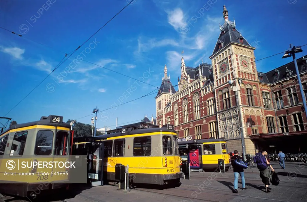 Tramway in front of the central train station built in the late 19th century, Amsterdam, The Netherlands