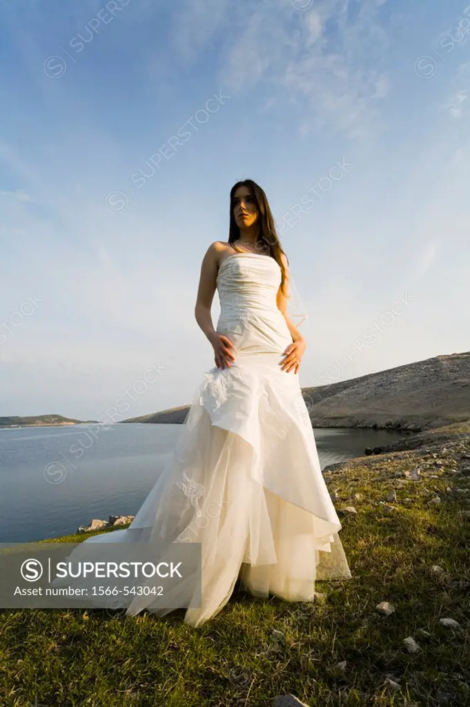 Beautiful bride standing in late afternoon light