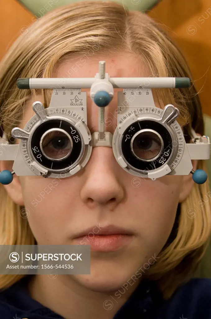 Teenage girl having her eyes tested by an optician