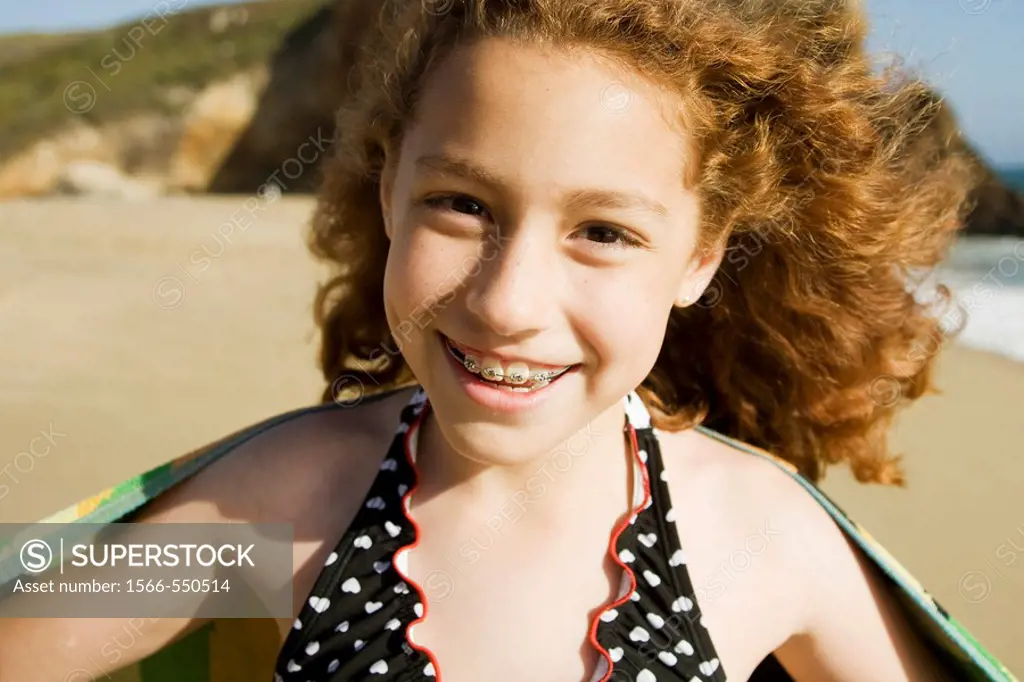 Happy young mixed race Mexican & caucasian girl at a beach in Santa Cruz, California