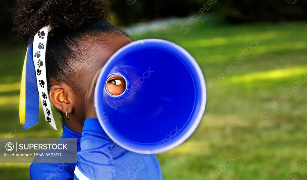 Tunnel vision  A little girl playfully peers through a megaphone