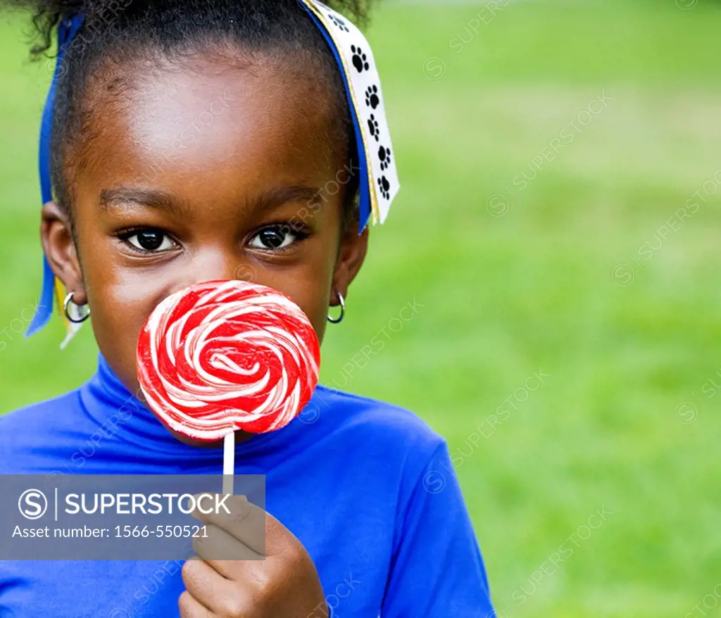 A little black girl and her swirly lollipop