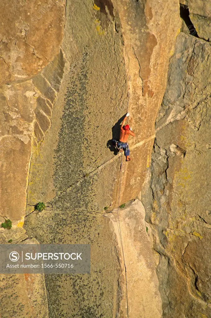 Man rock climbing a route called Strategic Defense which is rated 5,11 and located on Morning Glory Spire at The City Of Rocks National Reserve in sou...