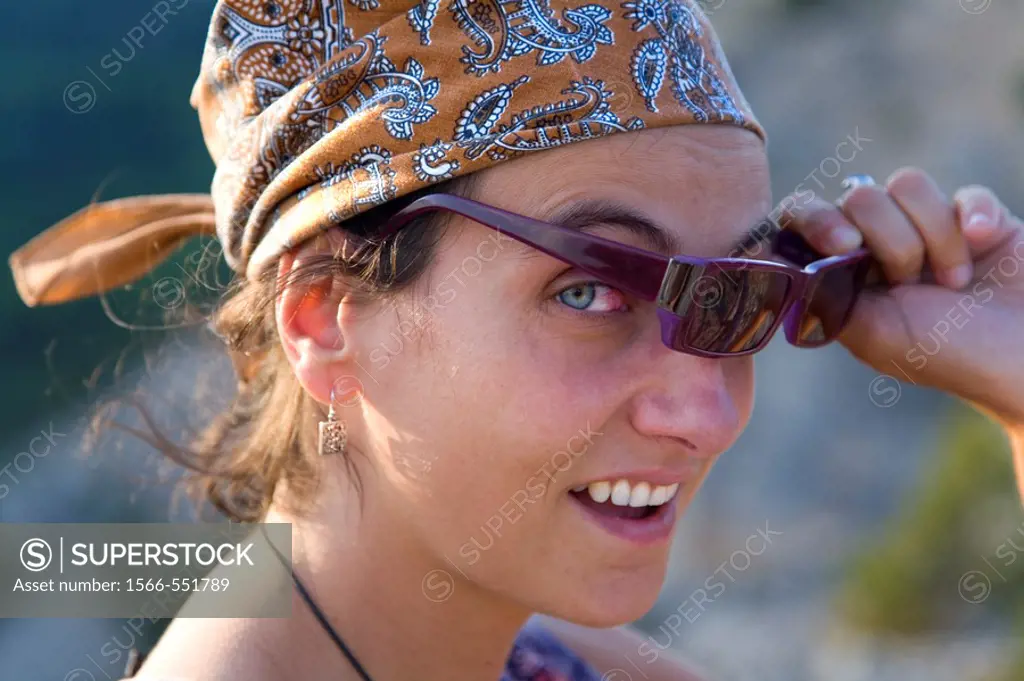 young woman with a headscarf and sunglasses