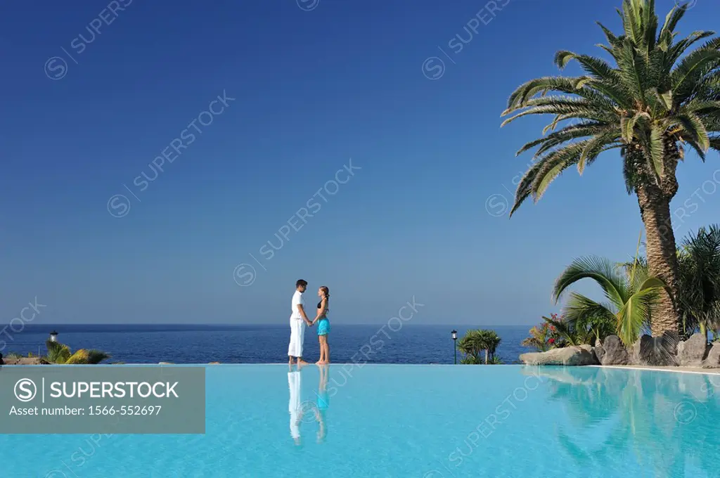 Love face to face with infinity pool reflection