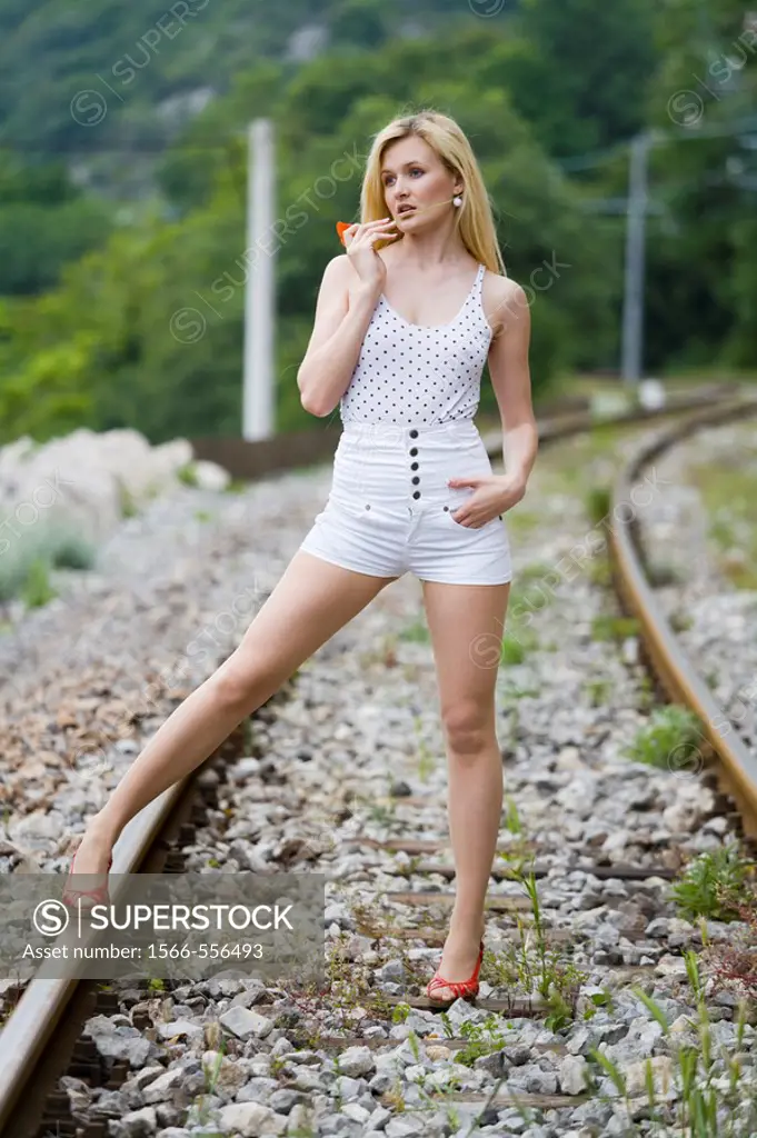 Posing on the rails, sexy young woman