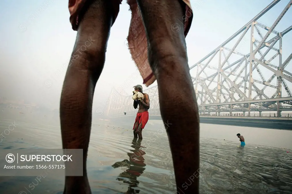 Sadhu by the Howrah Bridge. Hooghly River. Kolkata. Ganges River. India.