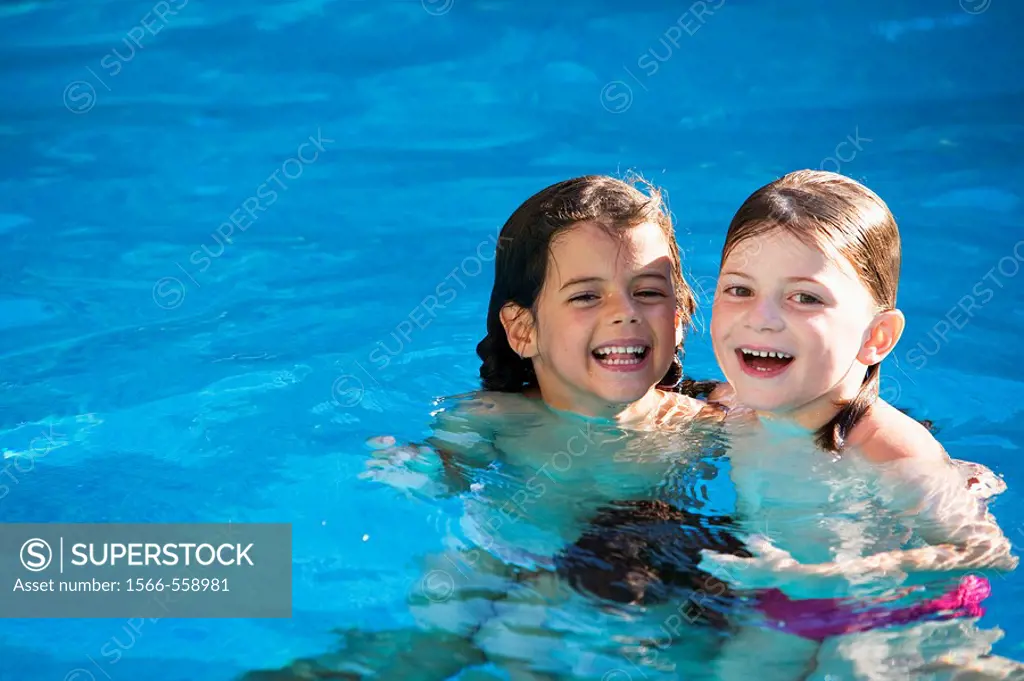 Two caucasian girls in the swimming pool