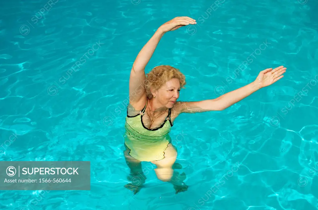 senior woman doing aquagym in a swimming pool