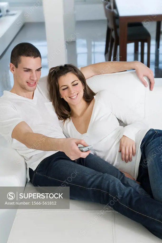 Couple enjoying leisure at home watching TV