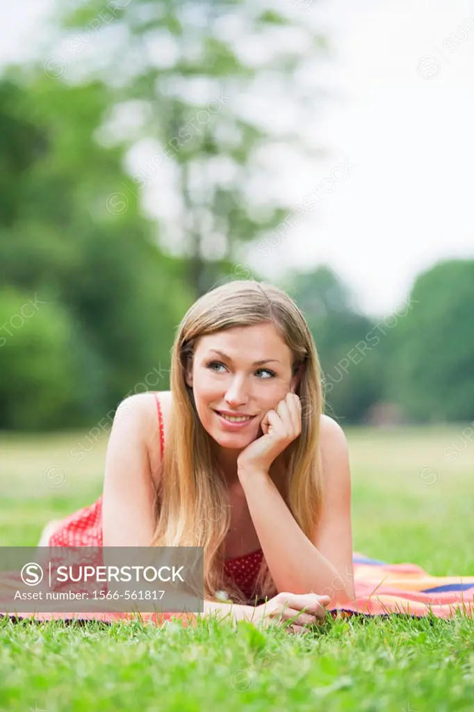 Portrait of a pensive smiling woman in the park