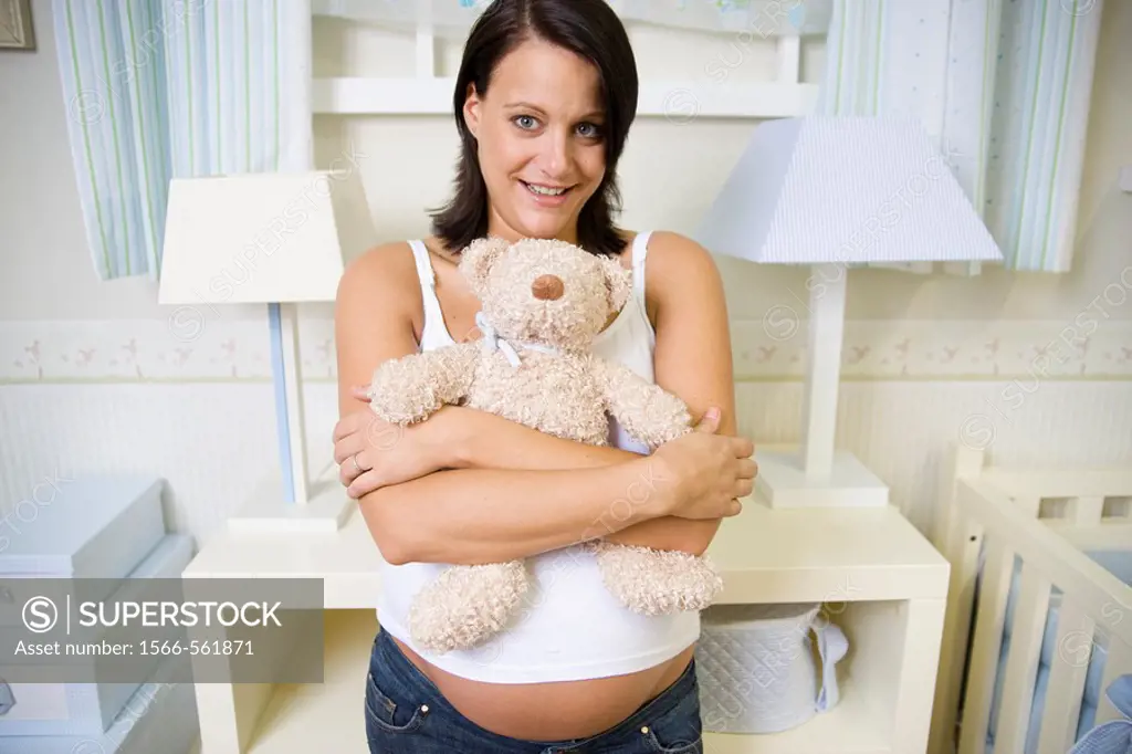Pregnant women in the baby´s room.