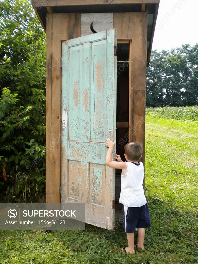 Small Boy Going Into Outhouse