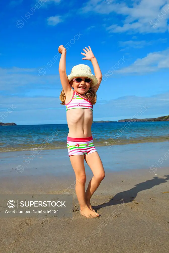 girl playing on sandy beach, Sutherland, Scotland