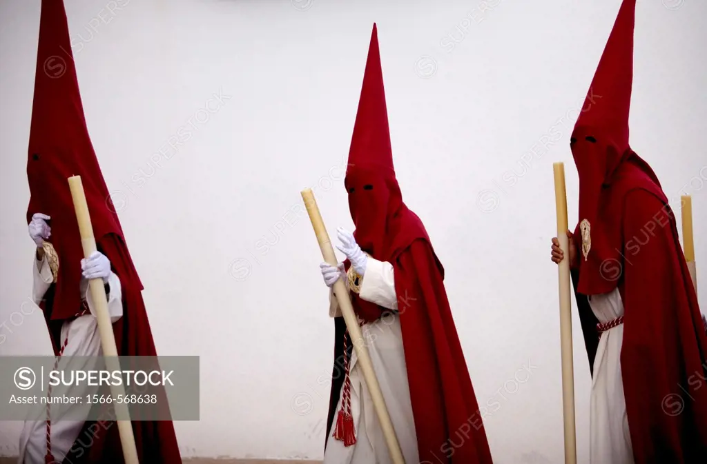 Penitents walk in a street during Easter Holy Week celebrations in Espera village, Cadiz province, Andalusia, Spain.