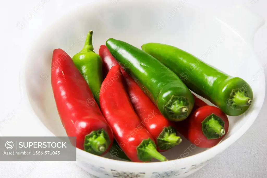 Red and Green Chili Peppers in a White Dish